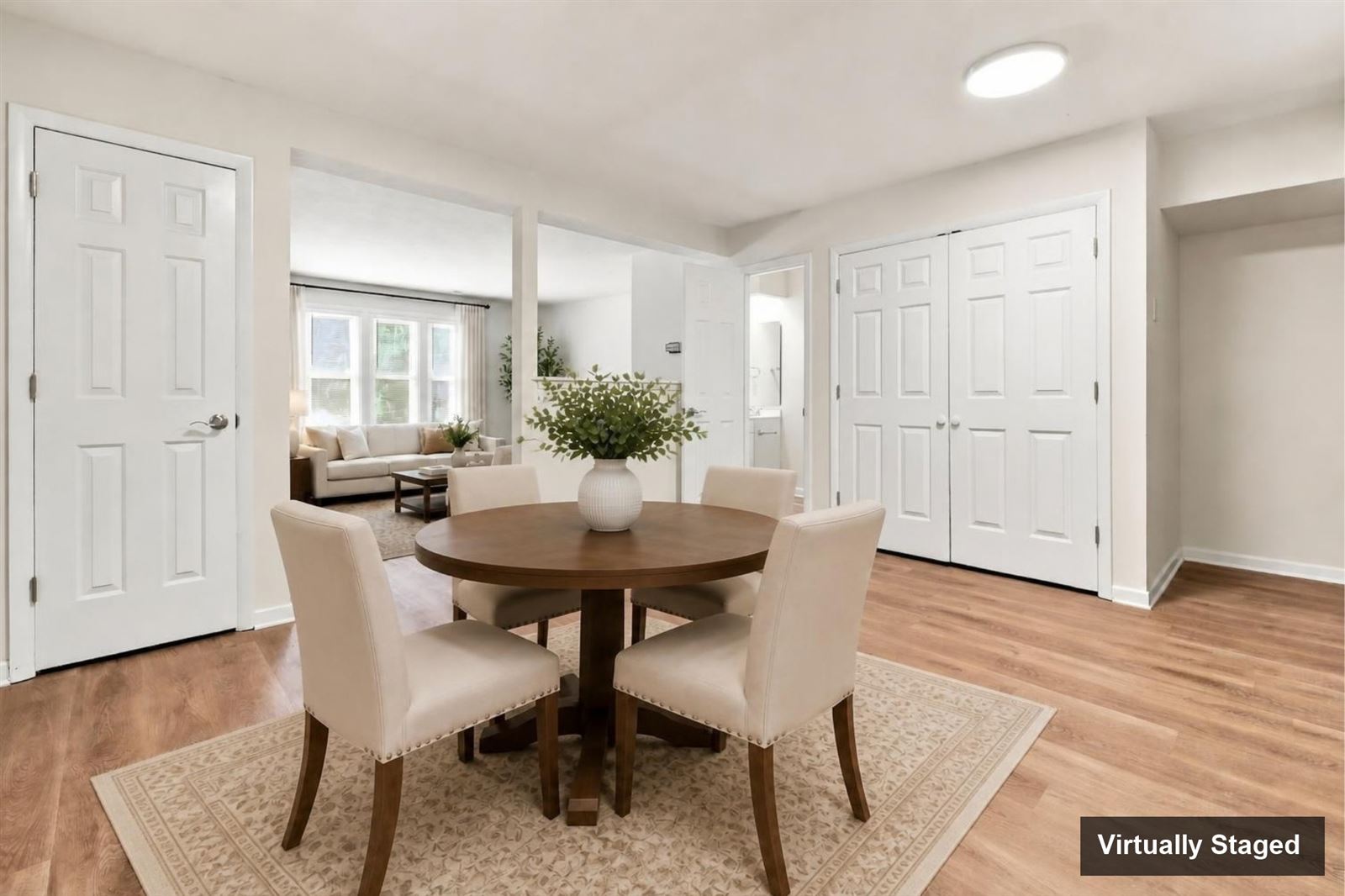 Dining area looking toward the living room, virtually staged