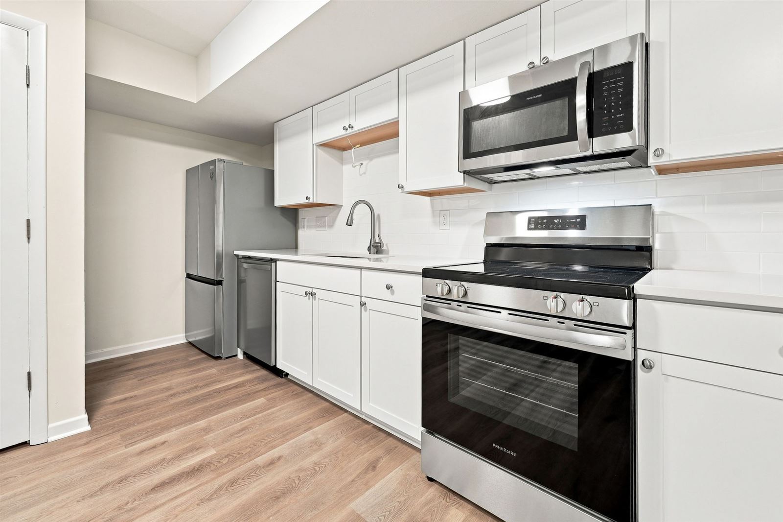 Kitchen with stainless range and microwave