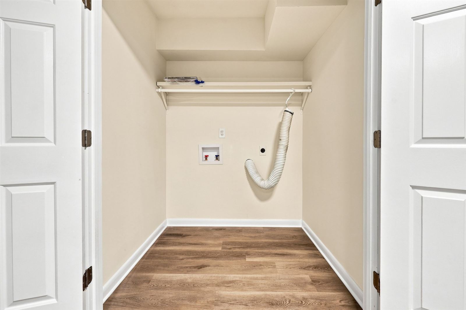 Main level laundry closet with washer and dryer hookups