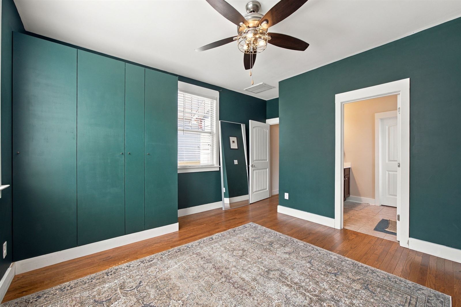 Primary bedroom's wall of built-in wardrobe cabinets