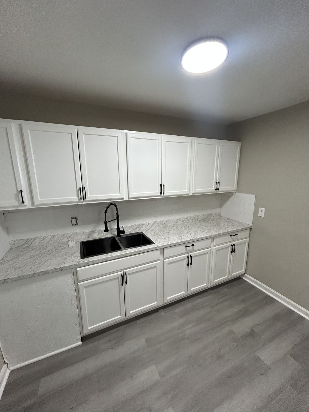 Kitchen with white shaker-style cabinets