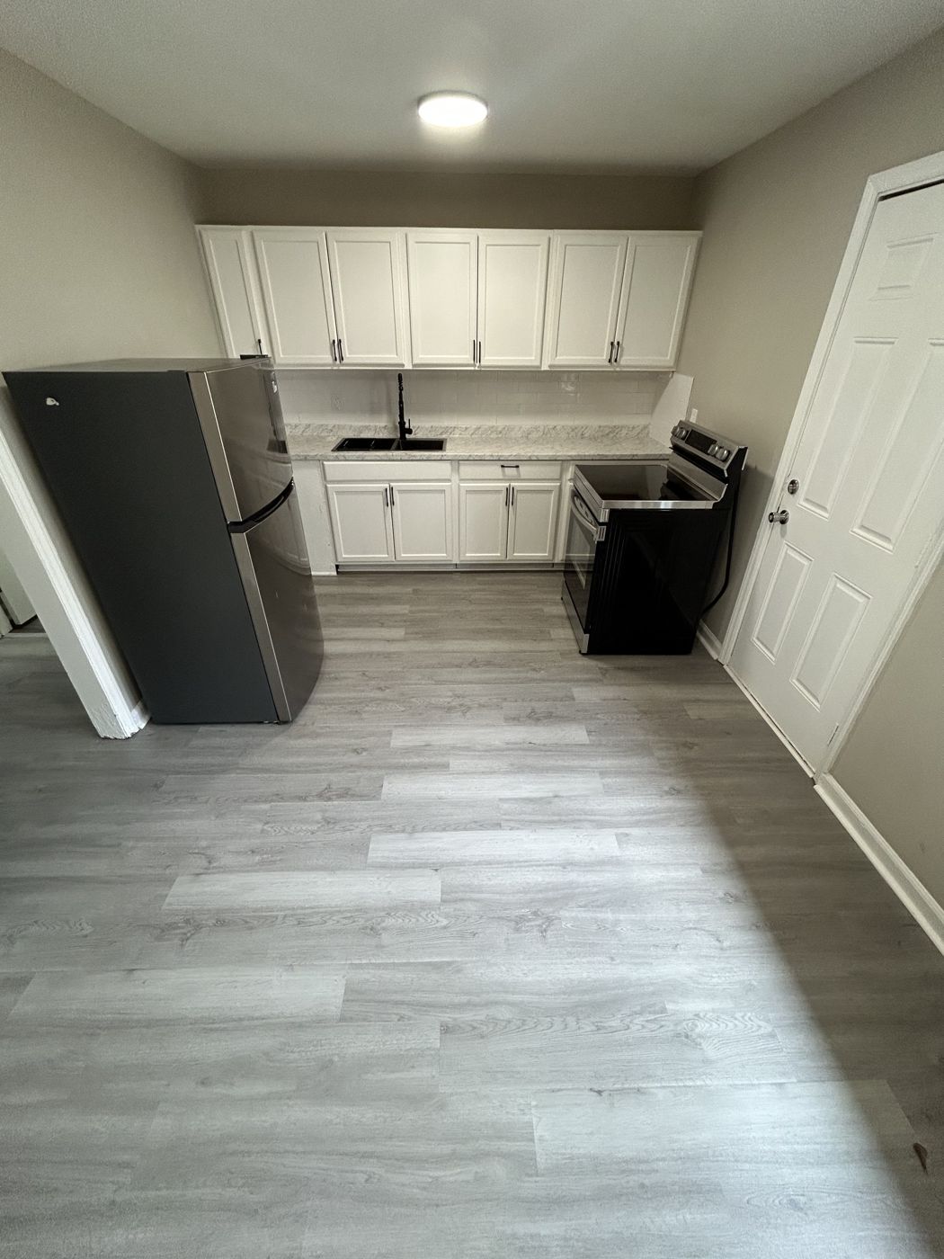 Kitchen with stainless refrigerator