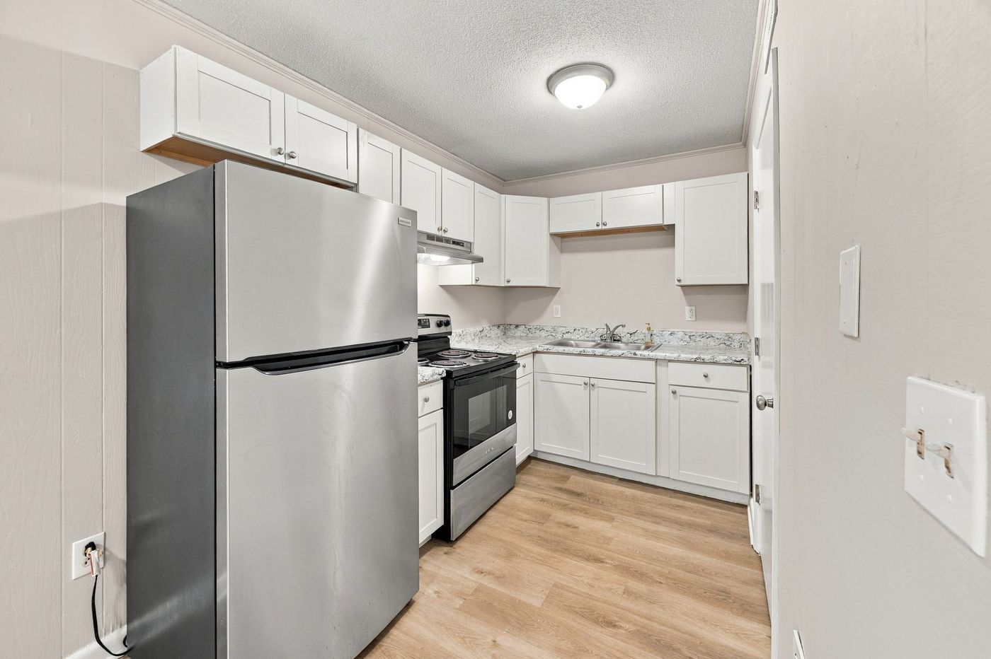 Kitchen with white cabinetry and stainless appliances