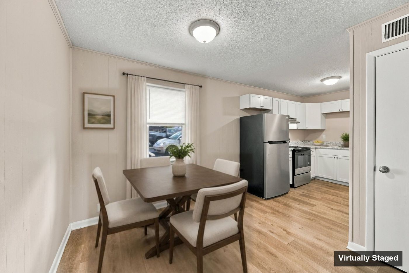 Dining area and kitchen, virtually staged
